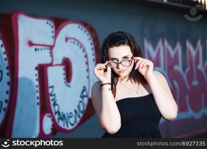 Attractive girl on a wall background with graffiti. close-up