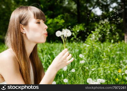 attractive girl on the field of dandelions