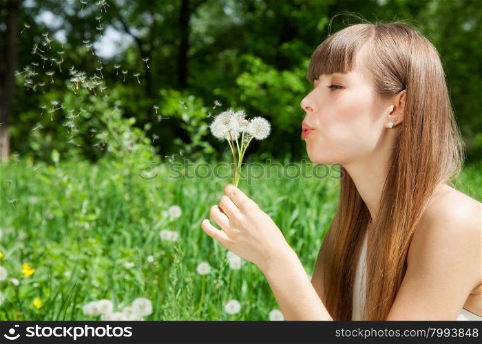 attractive girl on the field of dandelions