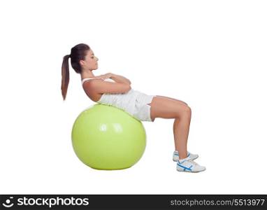 Attractive girl practicing abdominal on a big ball isolated on a white background