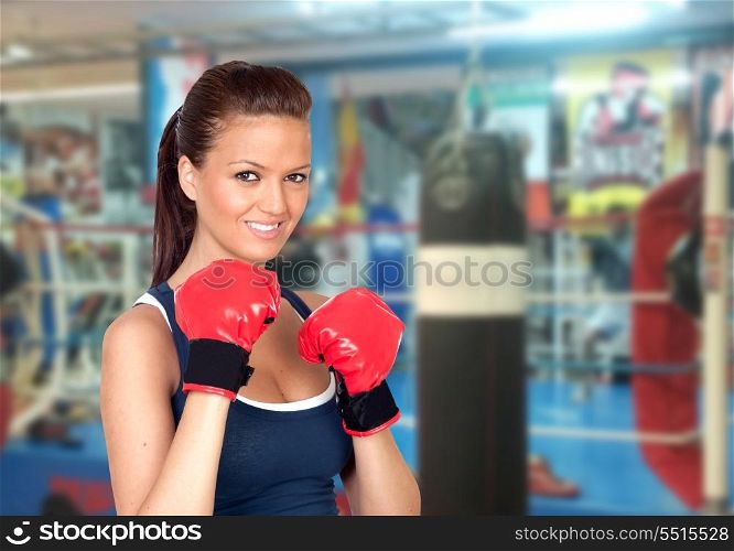 Attractive girl practicing boxing in the gym