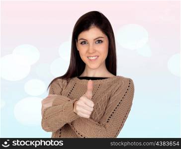 Attractive girl saying OK isolated on a blue and pink background with lights