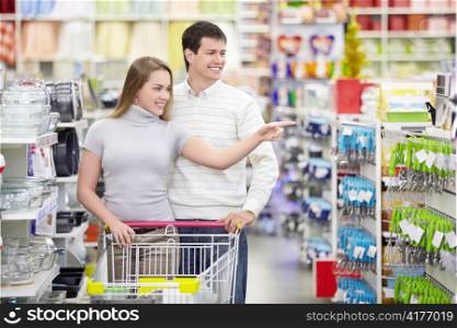 Attractive girl shows a man in the direction of the store