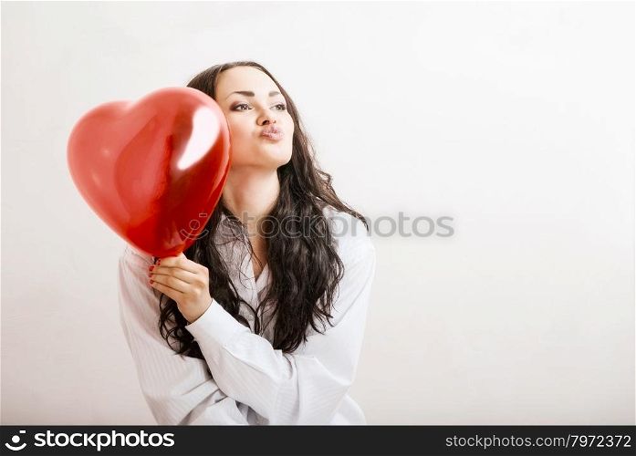 attractive girl with a red heart in the hands