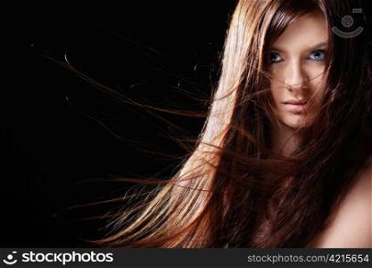 Attractive girl with developing hair on a black background