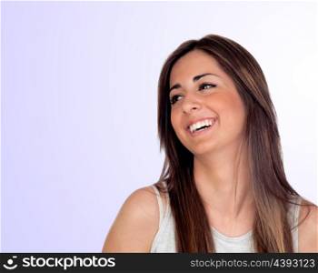 Attractive girl with long hair laughing isolated on blue background