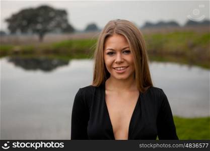 Attractive girl with sexy black shirt in the field