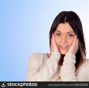 Attractive girl with the hands on her face isolated on blue background