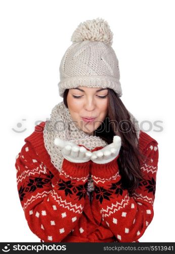 Attractive girl with with wool hat and scarf throwing a kiss isolated on white