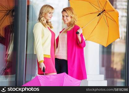 Attractive girlfreinds carrying the colorful umbrellas
