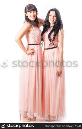 attractive girls in pink dresses. on white