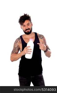 Attractive guy holding a milk bottle isolated on a white background