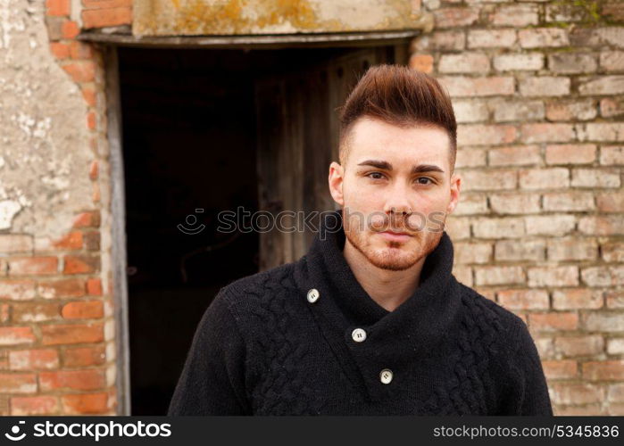 Attractive guy in a old house with black jersey