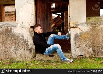 Attractive guy in a old house with black jersey