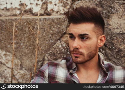 Attractive guy in a old house with plaid shirt