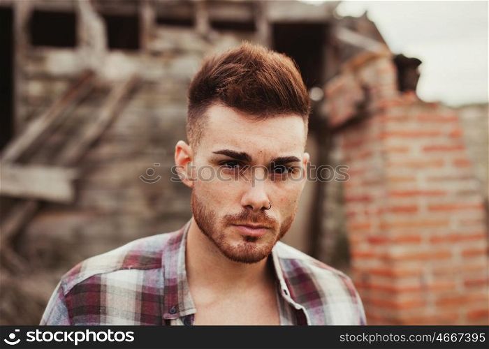 Attractive guy in a old house with plaid shirt