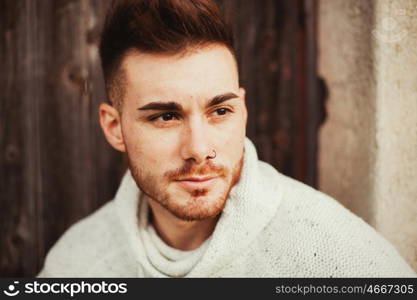 Attractive guy in a old house with white jersey