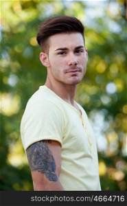 Attractive guy in the park with yellow t-shirt
