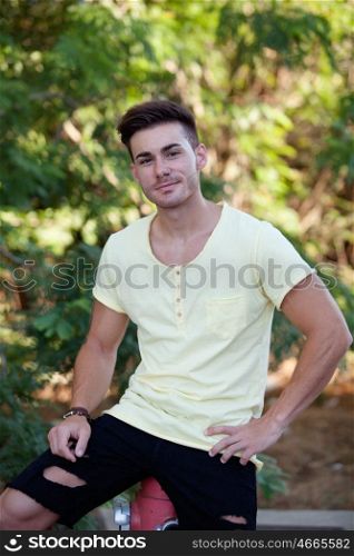 Attractive guy in the park with yellow t-shirt