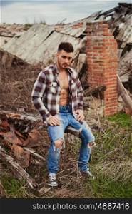 Attractive guy showing his strong chest and abs with the plaid shirt open