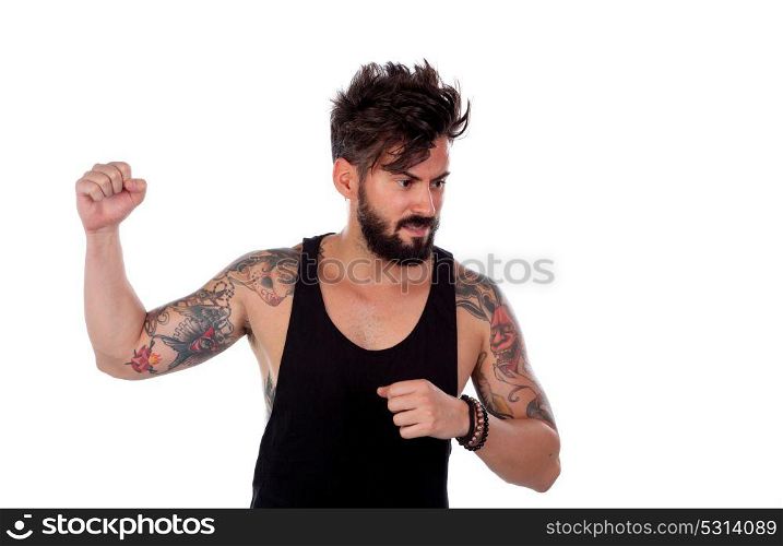 Attractive guy threatening with his fist raised isolated on a white background