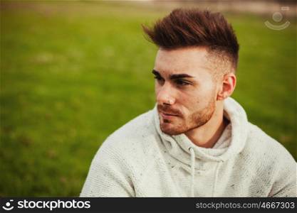 Attractive guy with beard in a green meadow