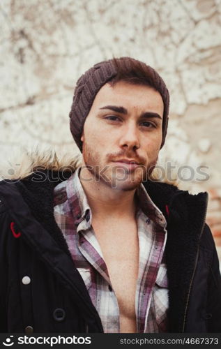 Attractive guy with black wool hat at the street