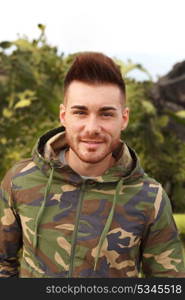 Attractive guy with military jacket and plants background