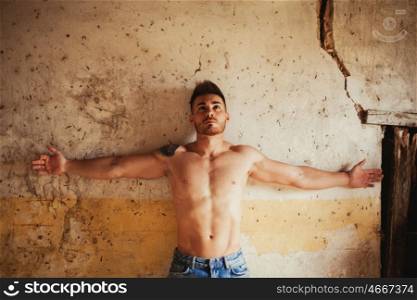 Attractive guy with the torso discovered showing his muscles