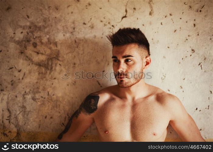 Attractive guy with the torso discovered showing his muscles