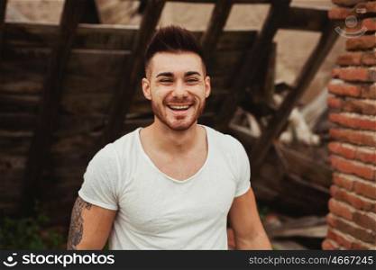 Attractive guy with white t-shirt in a old house. Image for ad
