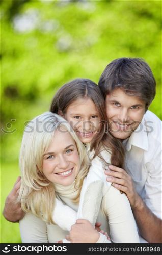 Attractive happy family with a child outdoors