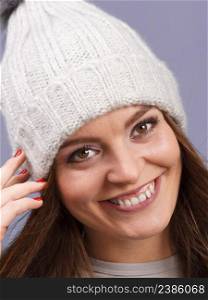 Attractive happy smiling woman long hair girl in winter wool cap studio shot on violet.. woman wearing winter wool cap portrait