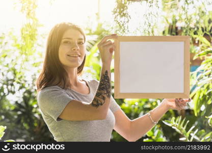 attractive happy woman holding frame plants