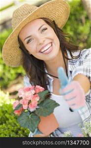 Attractive Happy Young Adult Woman Wearing Hat Gardening Outdoors.