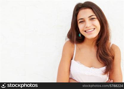 Attractive Hispanic Teenage Girl Leaning Against Wall