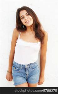 Attractive Hispanic Teenage Girl Leaning Against Wall