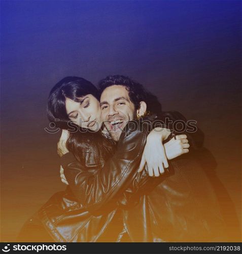 attractive lady hugging laughing guy leather jackets