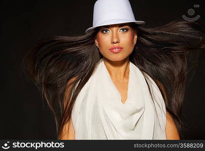 Attractive lady in white hat and blowing hair