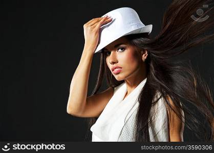 Attractive lady in white hat and blowing hair