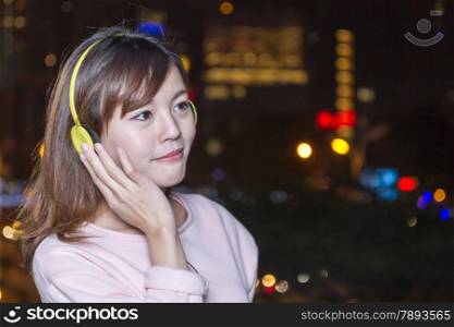 Attractive Malaysian Woman With Yellow Headphones