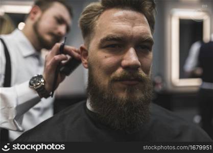 attractive man having hair cut