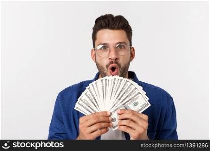 Attractive man is holding cash money in one hand, on isolated white background.. Attractive man is holding cash money in one hand, on isolated white background