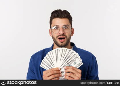 Attractive man is holding cash money in one hand, on isolated white background.. Attractive man is holding cash money in one hand, on isolated white background