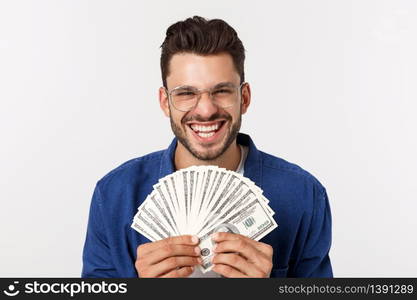 Attractive man is holding cash money in one hand, on isolated white background.. Attractive man is holding cash money in one hand, on isolated white background