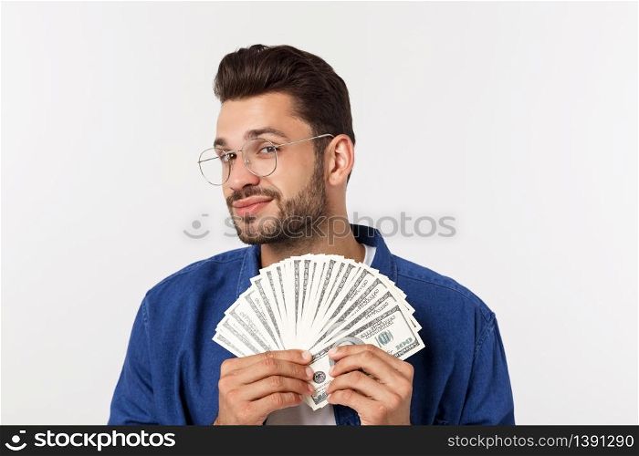 Attractive man is holding cash money in one hand, on isolated white background.. Attractive man is holding cash money in one hand, on isolated white background