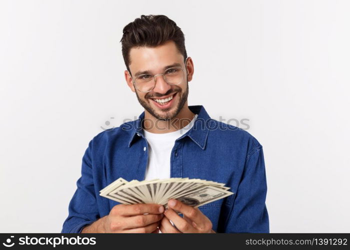 Attractive man is holding cash money in one hand, on isolated white background.. Attractive man is holding cash money in one hand, on isolated white background