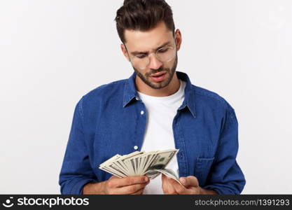 Attractive man is holding cash money in one hand, on isolated white background.. Attractive man is holding cash money in one hand, on isolated white background