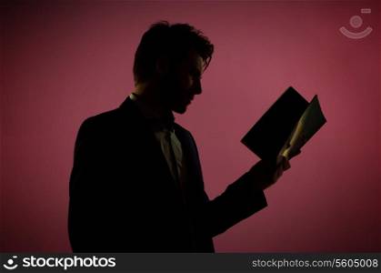Attractive man reading the magazine