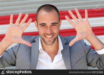 Attractive man showing hand palms to camera